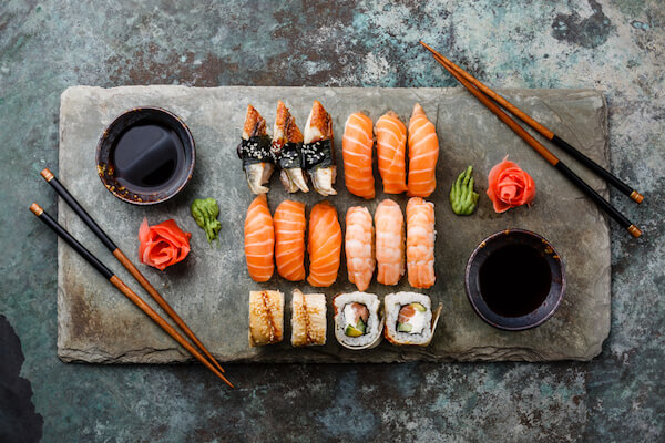 Sushi platter with wasabi, pickled ginger roses and chopsticks