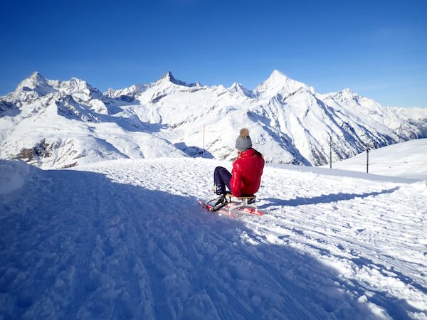 Girl in the Swiss mountains on Sledge - Taffpixture/shutterstock